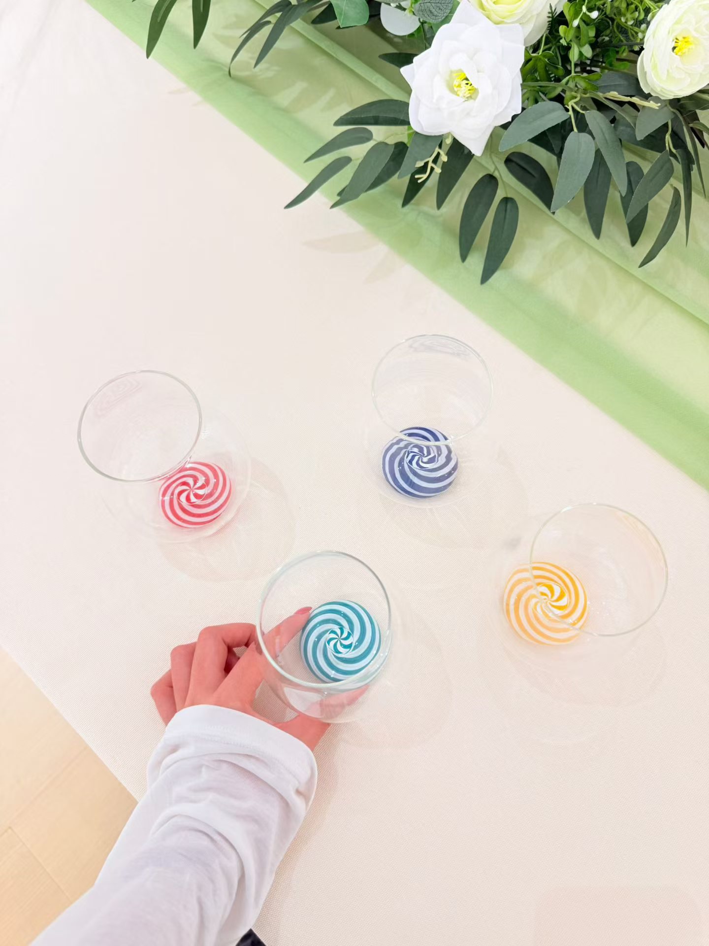 Colorful Swirl-Base Glass Collection featuring custom red, blue, teal, and orange weighted glass bases for wholesale and OEM branding